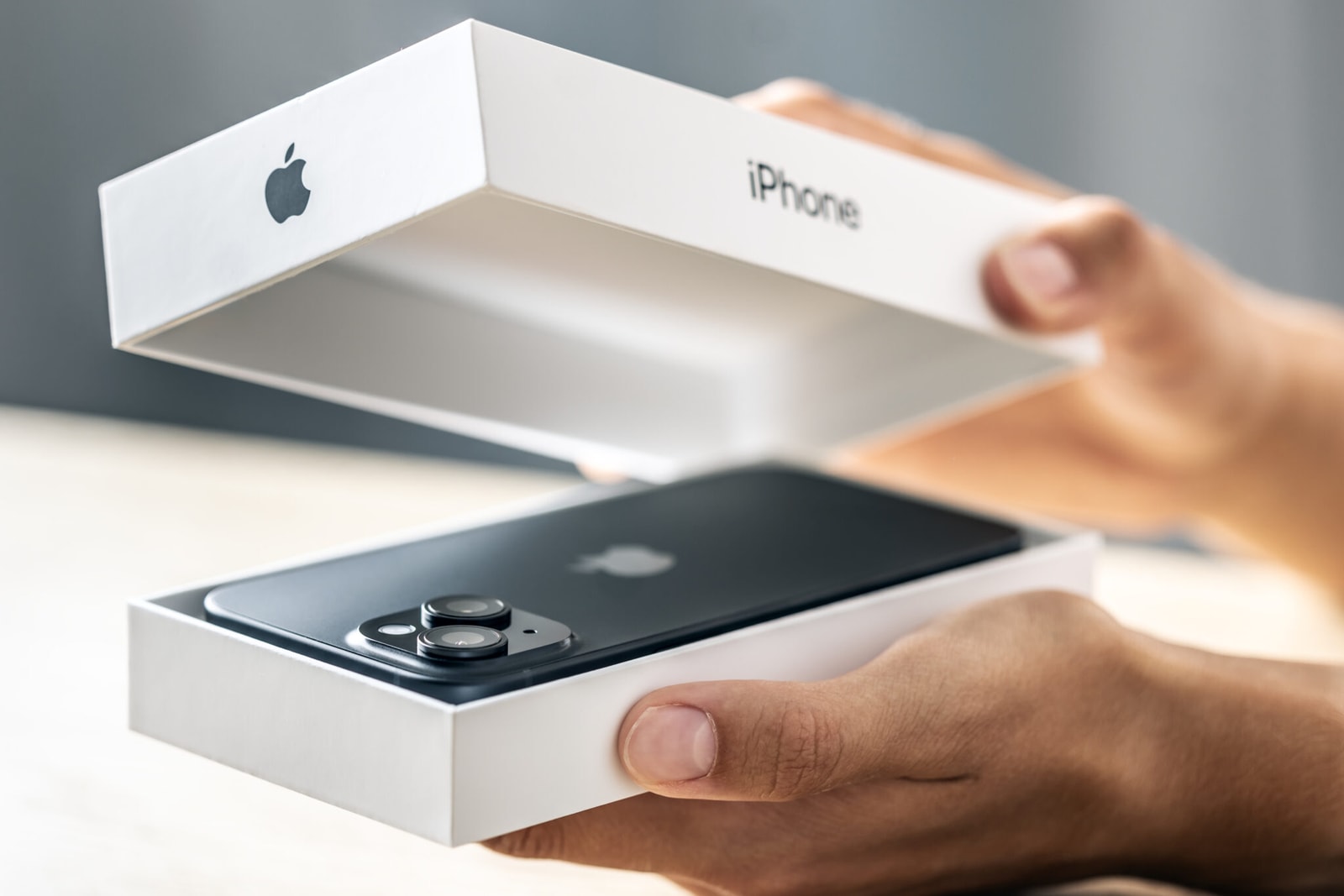 Prague Czech Republic: September – 09 – 2024: A customer in an Apple Store holds a new iPhone smartphone in a box.